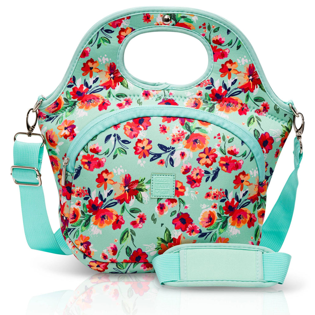 Floral patterned bag with a strap on a mint green background